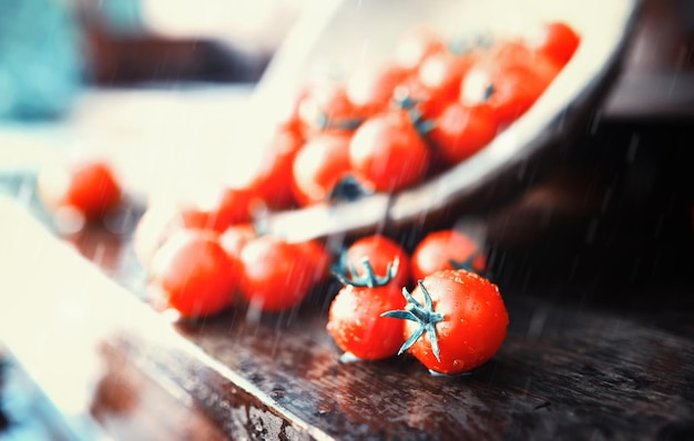 Fresh farm cherry tomatoes on a wooden background after the rain