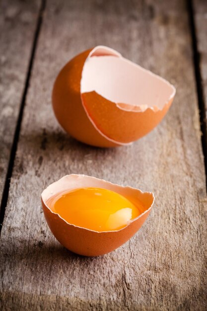 Fresh farm eggs closeup on a wooden rustic background