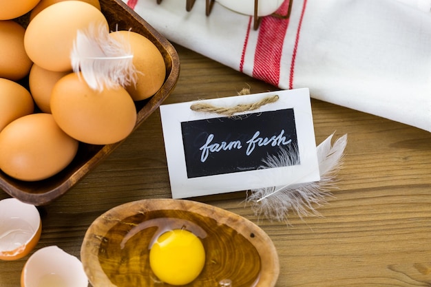 Fresh farm eggs, milk and butter on wood table.