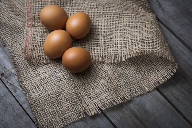 Fresh farm eggs on a wooden rustic background