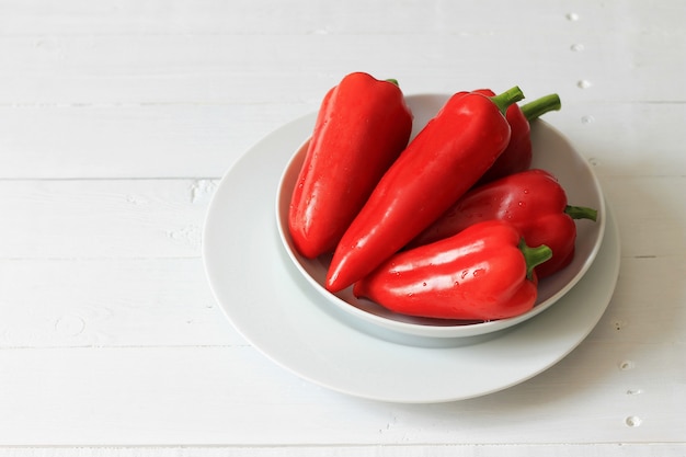 Fresh farm red bell pepper on a white plate