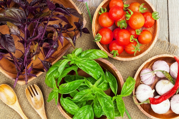 Fresh farmers tomatoes and basil on wood table