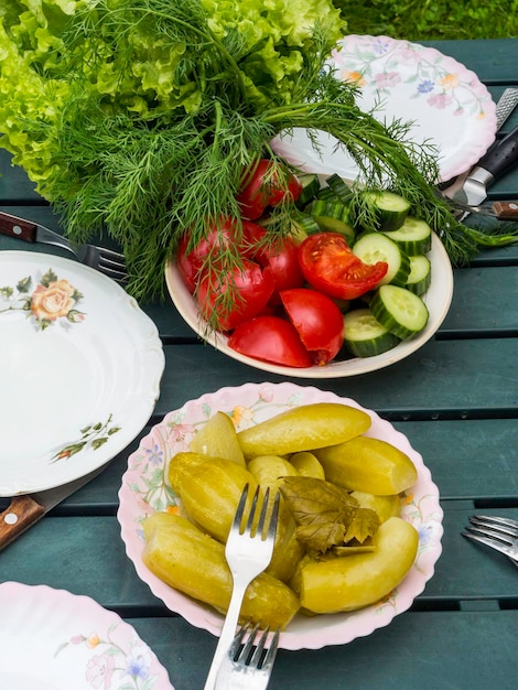 Fresh farmers tomatoes cucumbers dill salad on green table View from above