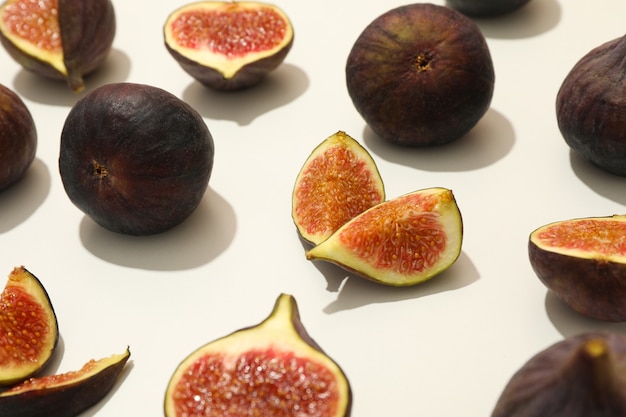 Fresh fig fruits and slices on white, close up