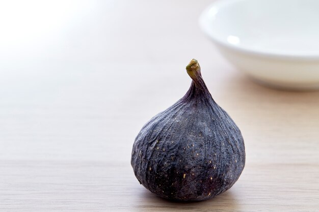 Fresh fig with plate on wooden