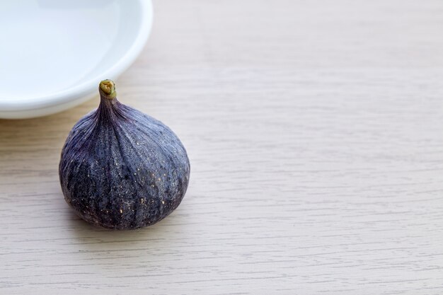 Fresh fig with plate on wooden