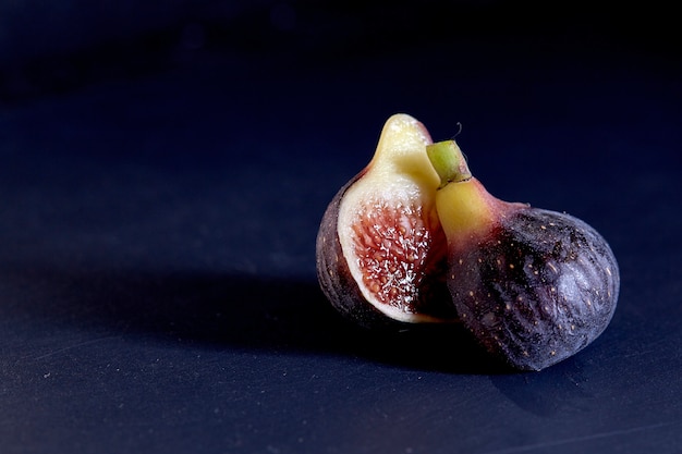 Fresh figs on black background