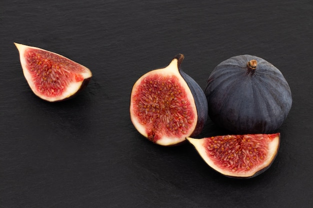 Fresh figs on dark, top view.