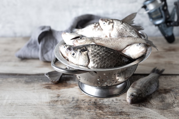 Fresh fish caught in the river on a wooden table.