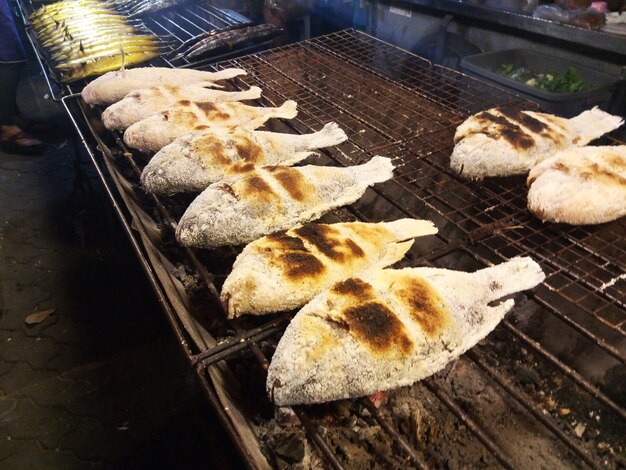 Fresh fish is grilled at the fish market.