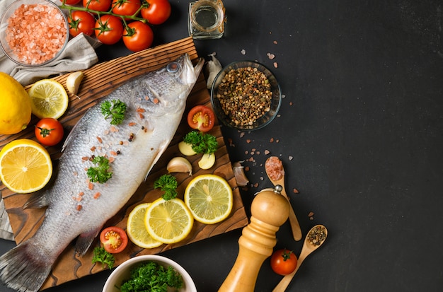 Fresh fish seabass and ingredients for cooking. 