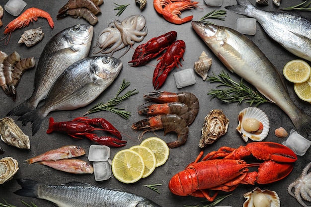 Fresh fish and seafood on grey table flat lay