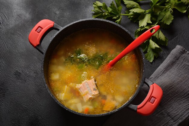 Fresh  fish soup on black background Salmon soup