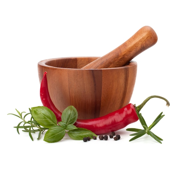 Fresh flavoring herbs and spices in wooden mortar