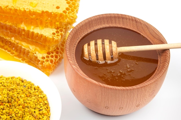 Fresh flower honey in combs and a wooden spoon vitamin food for health and life