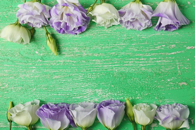 Fresh flowers frame on wooden background