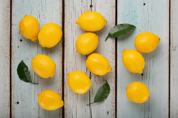 Fresh fragrant lemons on a blue wooden table