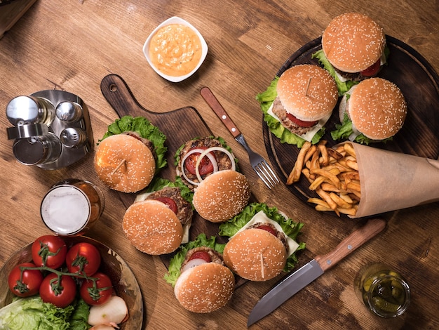 Fresh french fries next to delicious burgers on vintage restaurant.