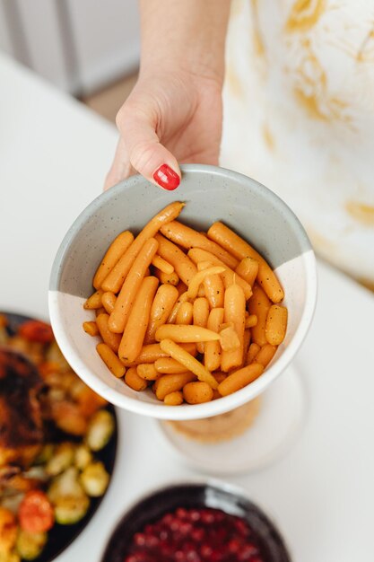 fresh french fries on a wood bucket with white dip sauce and fresh vegetables on background