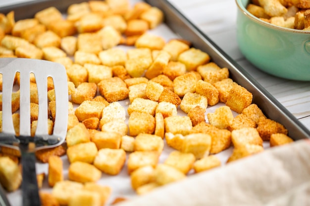 Fresh french toast croutons on baking sheet.