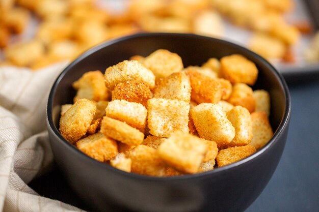 Fresh french toast croutons in black bowl.