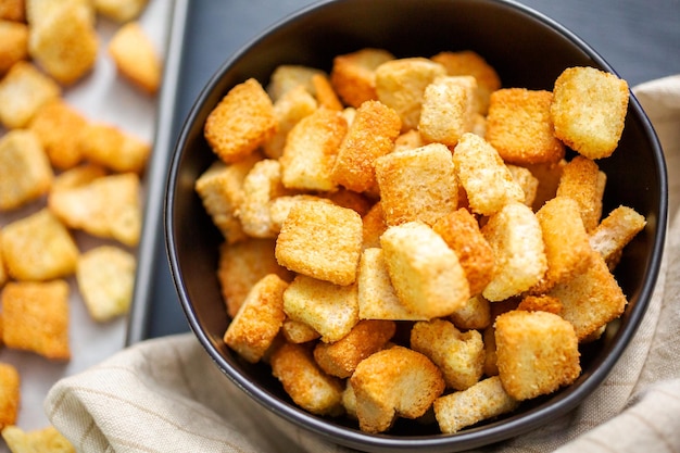 Fresh french toast croutons in black bowl.