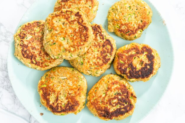 Fresh fried zucchini cakes on a plate.