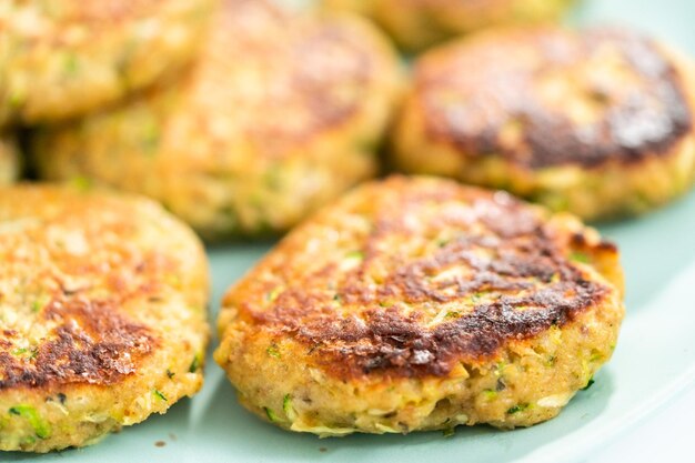 Fresh fried zucchini cakes on a plate.