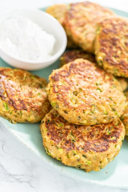 Fresh fried zucchini cakes on a plate.