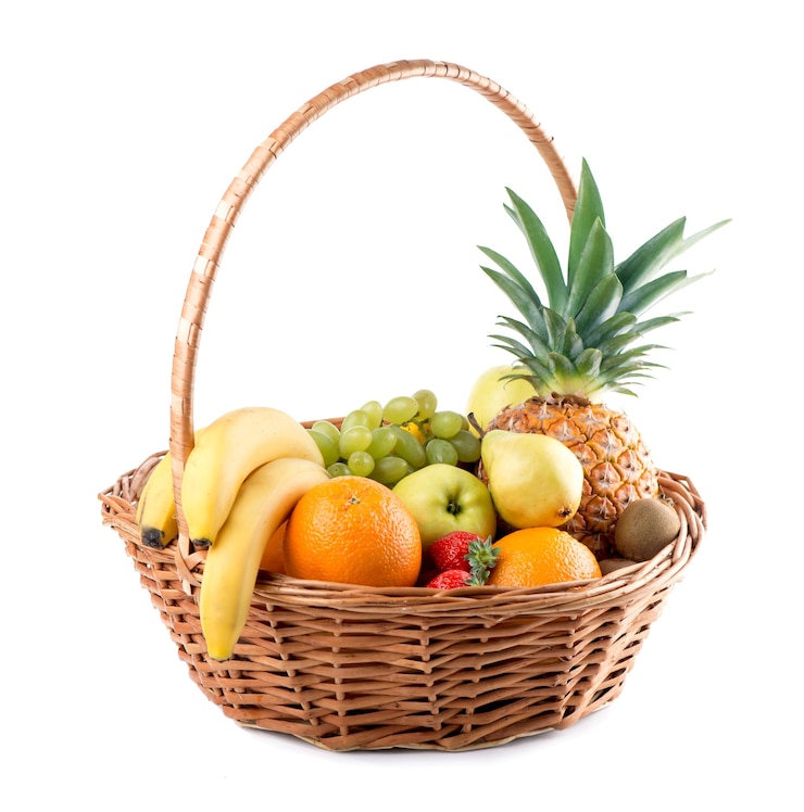 Photo fresh fruit in the basket against a white background