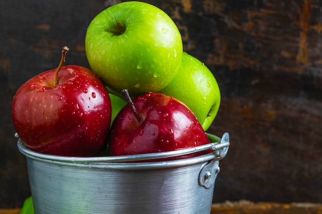 Fresh fruit, green apple and red apple in a bucket