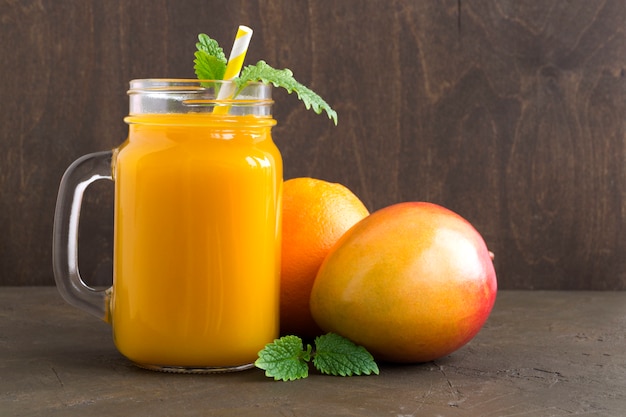 Fresh fruit juice in the jar. on dark background.