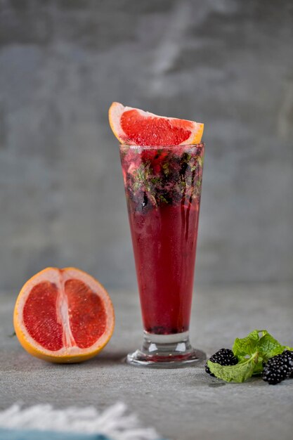 Fresh fruit mojito juice with raw fruit served in a glass side view of healthy drink