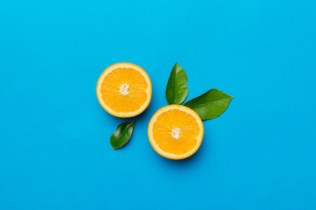 Fresh Fruit orange slices on colored background Top view Copy Space creative summer concept Half of citrus in minimal flat lay with copy space