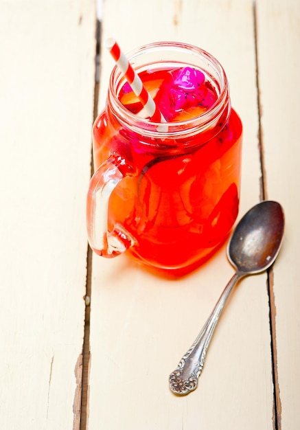 fresh fruit punch refreshing summer drink over white rustic wood table