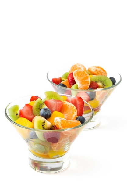 Fresh fruit salad in crystal bowl isolated on white