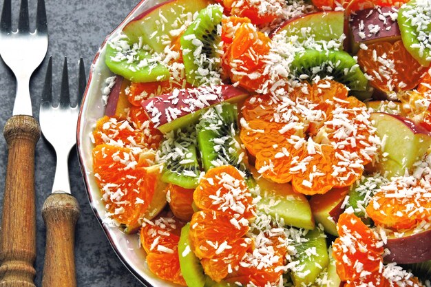 Fresh fruit salad. summer salad with tropical fruits. kiwi tangerine salad