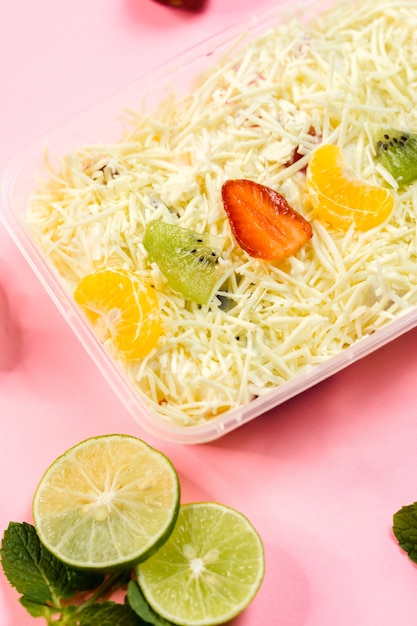 Photo fresh fruit salad topped with cheese.