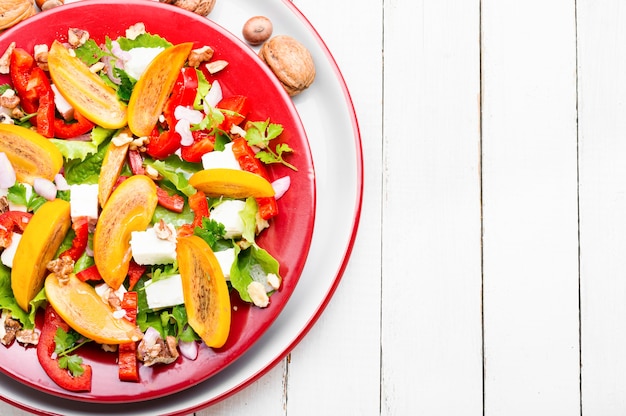 Fresh fruit salad with persimmons and cheese.Copy space