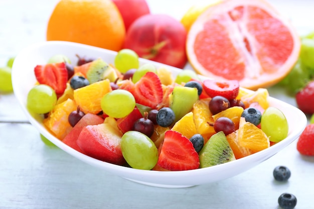 Fresh fruit salad on wooden table