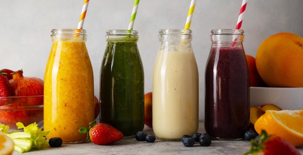 Fresh fruit smoothie bottles and sliced fruits healthy detox drinks