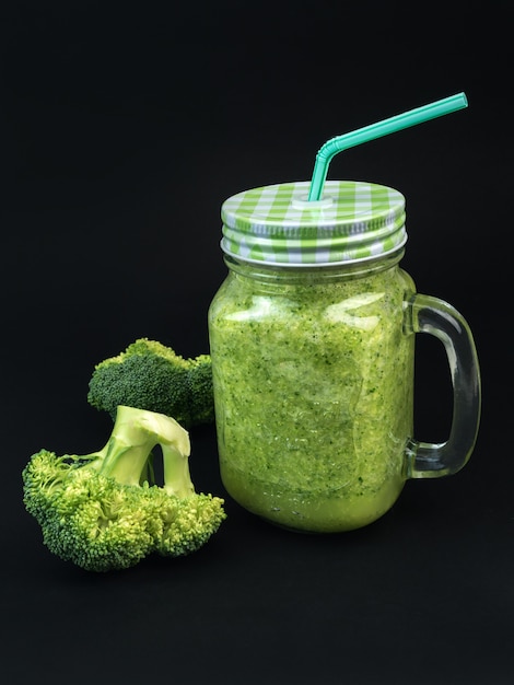 Fresh fruit vegetable broccoli celery smoothie bottle shake dark black