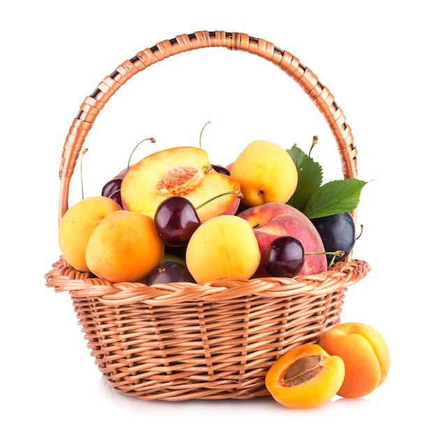 Fresh fruits in a basket isolated on white background