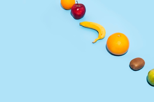 Photo fresh fruits on a blue background. top view, flat lay.