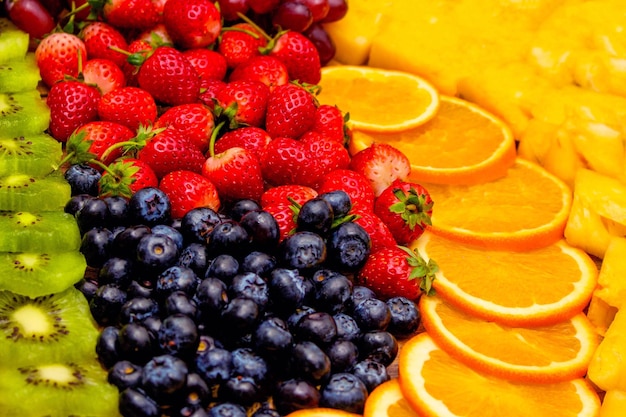 Fresh fruits concept Arrangement of kiwi strawberry and blueberry as background