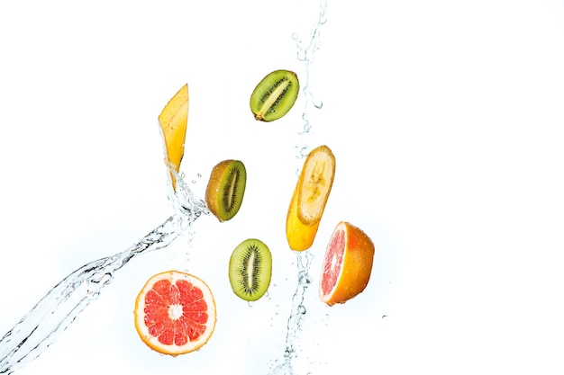 The fresh fruits falling with water splash, isolated on white background