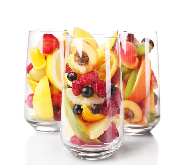 Fresh fruits salad in glasses isolated on white