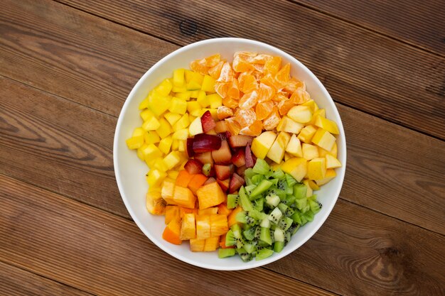 Fresh fruits salad - mango, citrus, kiwi fruit, plum and persimmon.