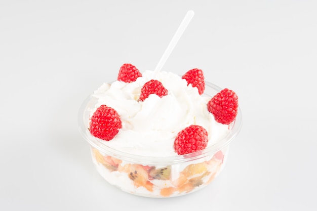 Fresh fruits salad with ice cream in bowl on table