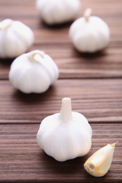 Fresh garlic on a brown wooden background